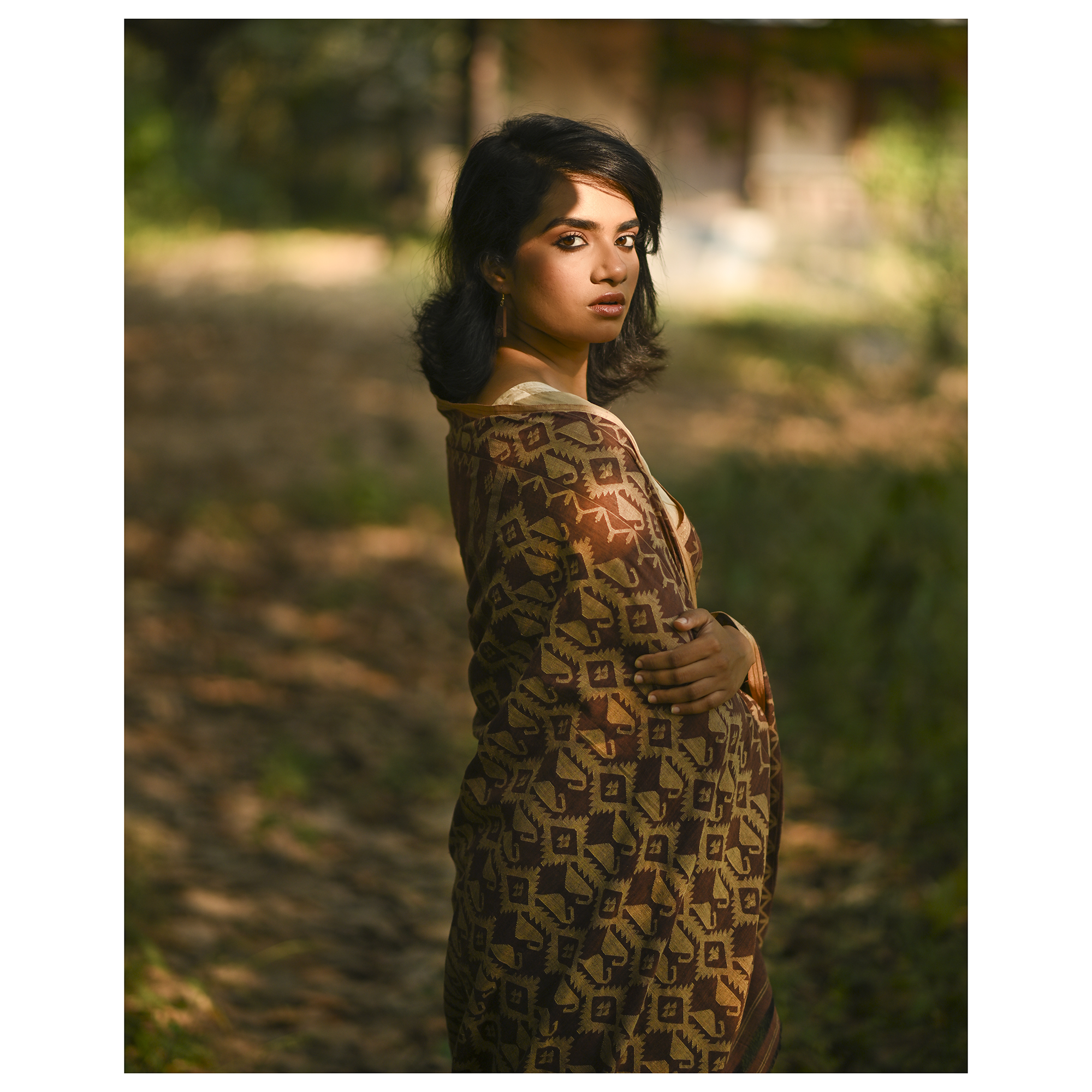 Model wearing the Cocoa Geometry Jamdani Saree, a handwoven deep cocoa brown with sand-beige weave Jamdani saree with geometric body motifs with woven butis and richly worked pallu with bold geometric detailing.