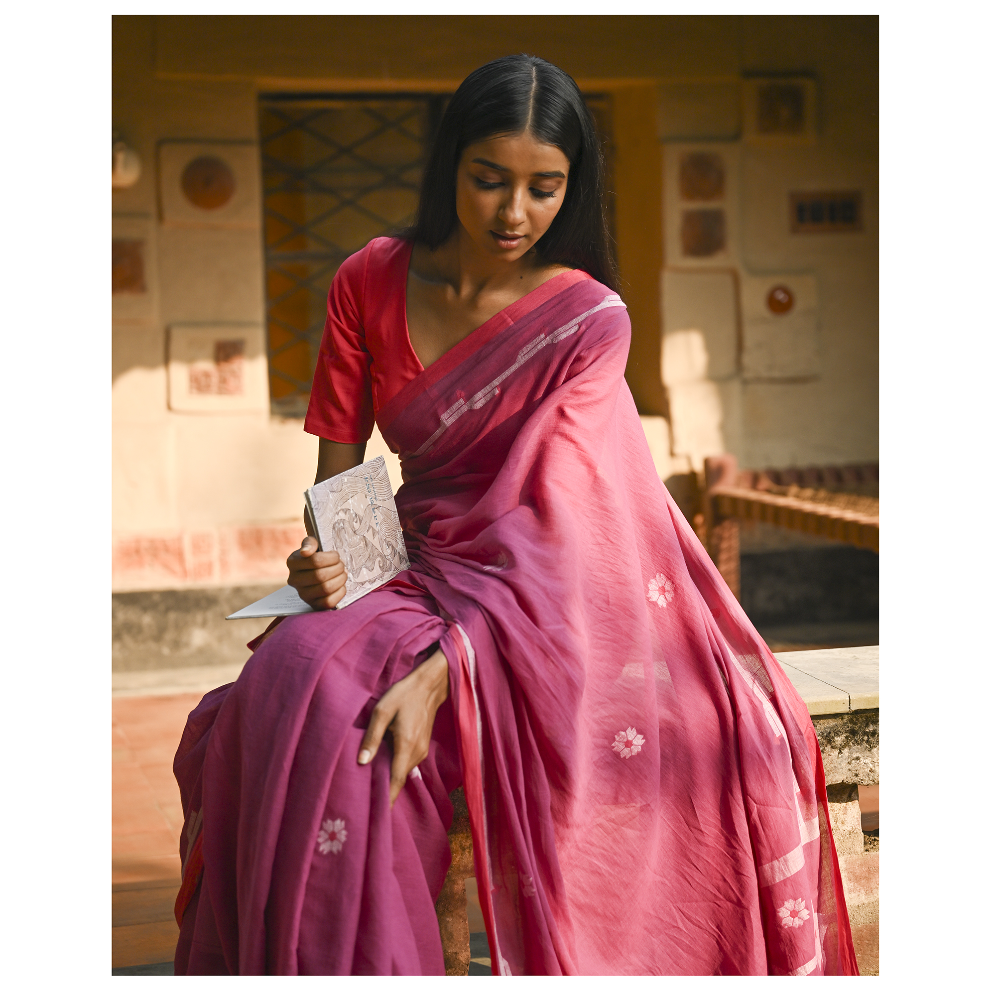 Model wearing the Rose Pink Buti Jamdani Saree, a handwoven vivid rose pink with soft white motifs Jamdani saree with airy white butis across an open field and lightly detailed pallu that keeps the drape airy.