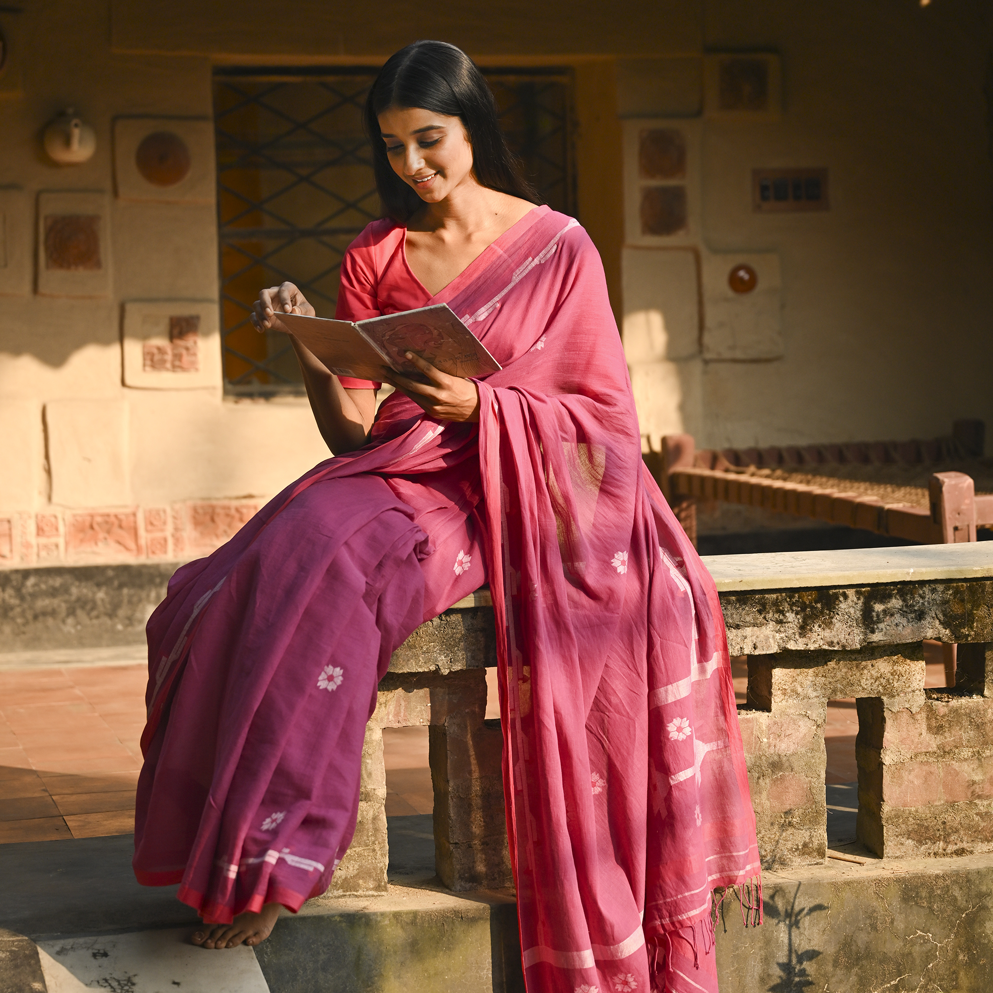 Model wearing the Rose Pink Buti Jamdani Saree, a handwoven vivid rose pink with soft white motifs Jamdani saree with airy white butis across an open field and lightly detailed pallu that keeps the drape airy.