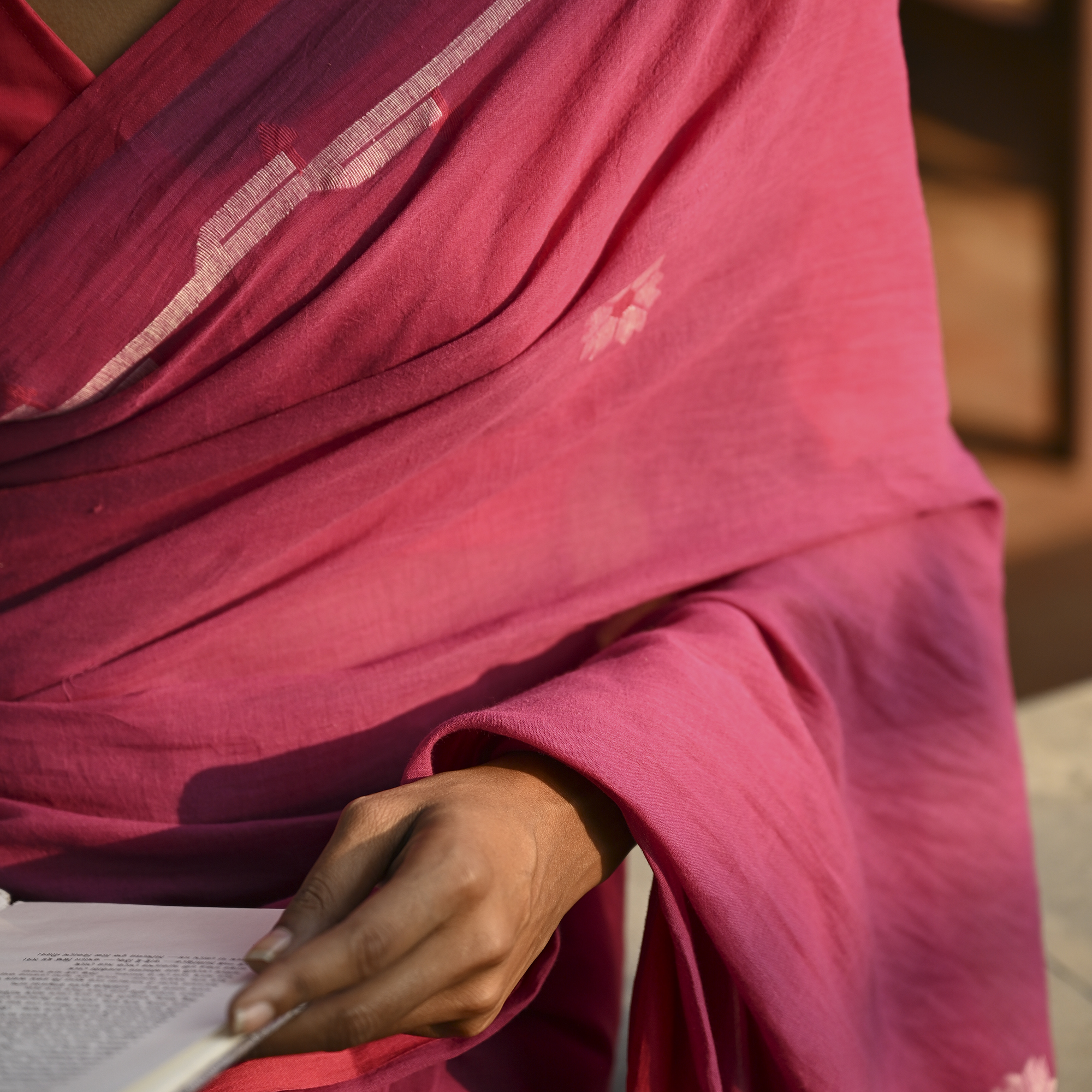 Model wearing the Rose Pink Buti Jamdani Saree, a handwoven vivid rose pink with soft white motifs Jamdani saree with airy white butis across an open field and lightly detailed pallu that keeps the drape airy.