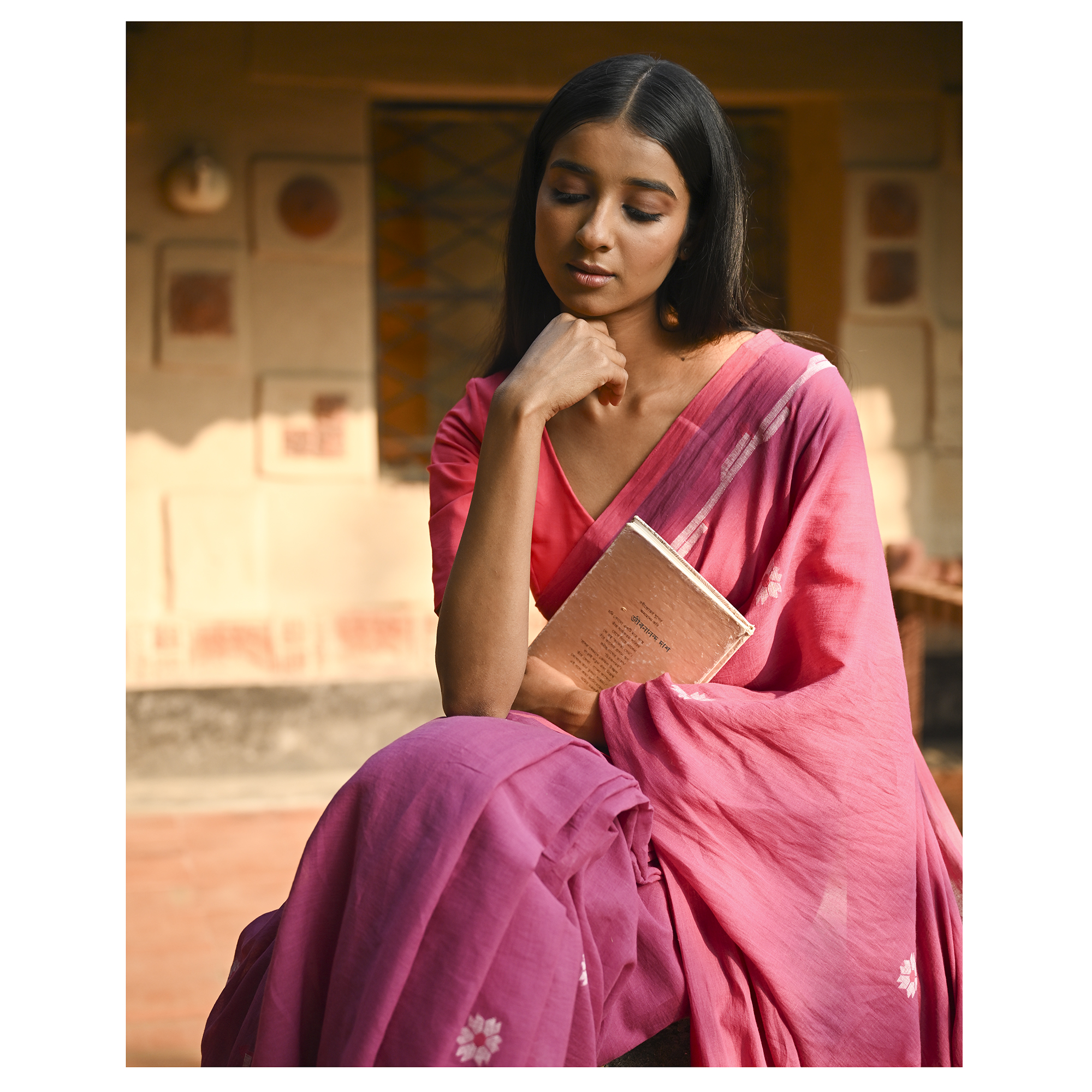 Model wearing the Rose Pink Buti Jamdani Saree, a handwoven vivid rose pink with soft white motifs Jamdani saree with airy white butis across an open field and lightly detailed pallu that keeps the drape airy.