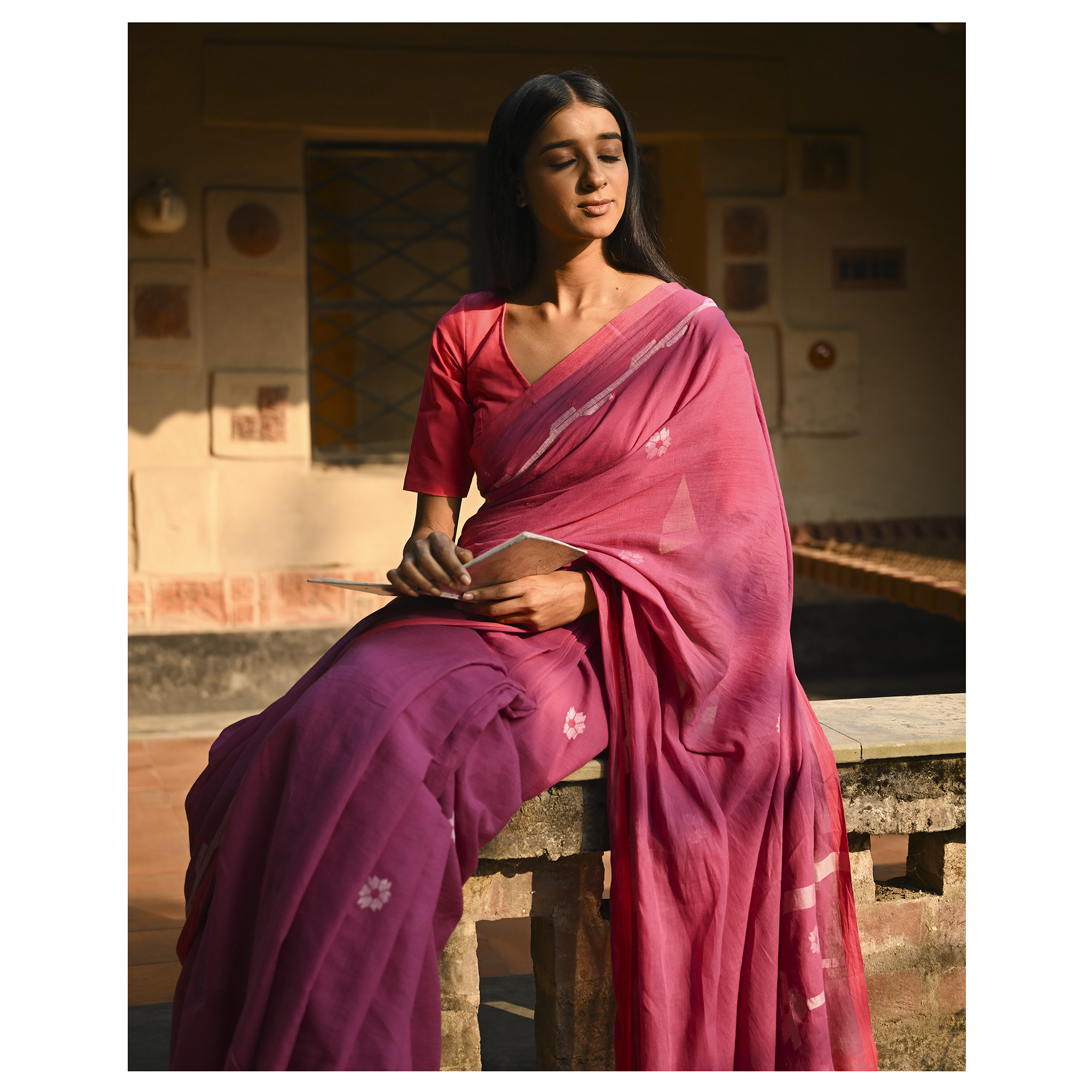 Model wearing the Rose Pink Buti Jamdani Saree, a handwoven vivid rose pink with soft white motifs Jamdani saree with airy white butis across an open field and lightly detailed pallu that keeps the drape airy.