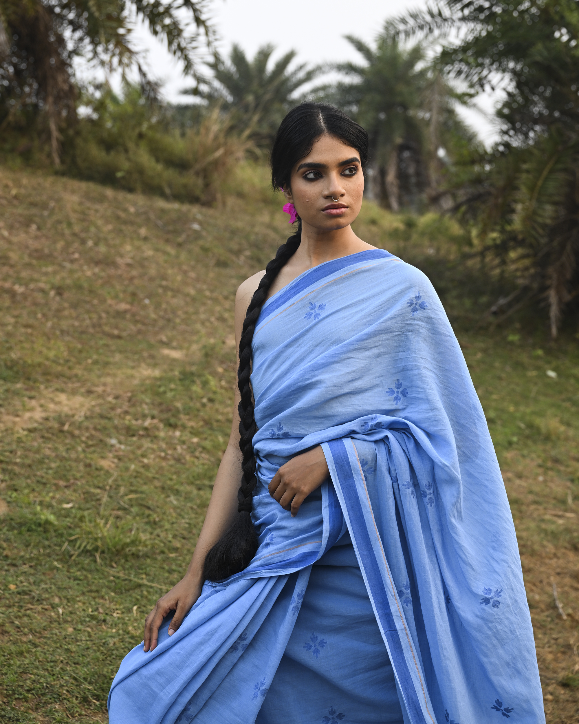 Model wearing the Powder Blue Floral Buti Jamdani Saree, a handwoven powder blue with tonal floral butis Jamdani saree with tonal floral butis scattered across the body and minimal pallu with a clean tonal finish.