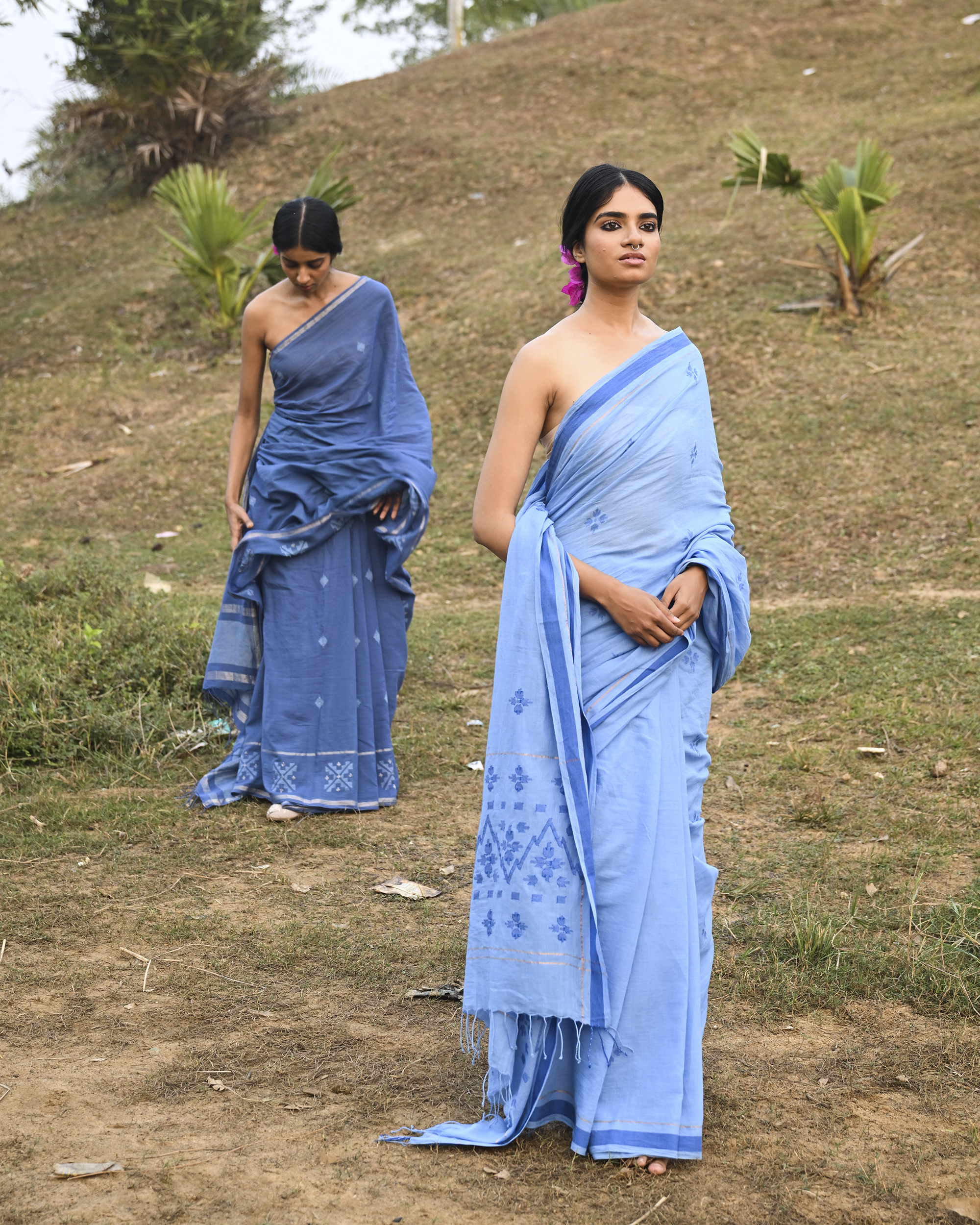 Model wearing the Powder Blue Floral Buti Jamdani Saree, a handwoven powder blue with tonal floral butis Jamdani saree with tonal floral butis scattered across the body and minimal pallu with a clean tonal finish.