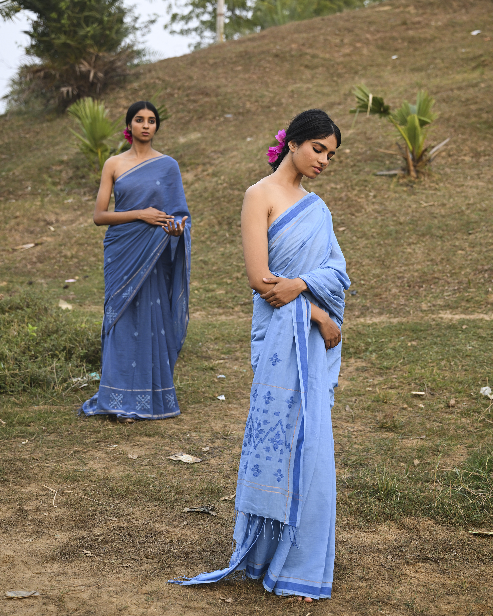 Model wearing the Powder Blue Floral Buti Jamdani Saree, a handwoven powder blue with tonal floral butis Jamdani saree with tonal floral butis scattered across the body and minimal pallu with a clean tonal finish.