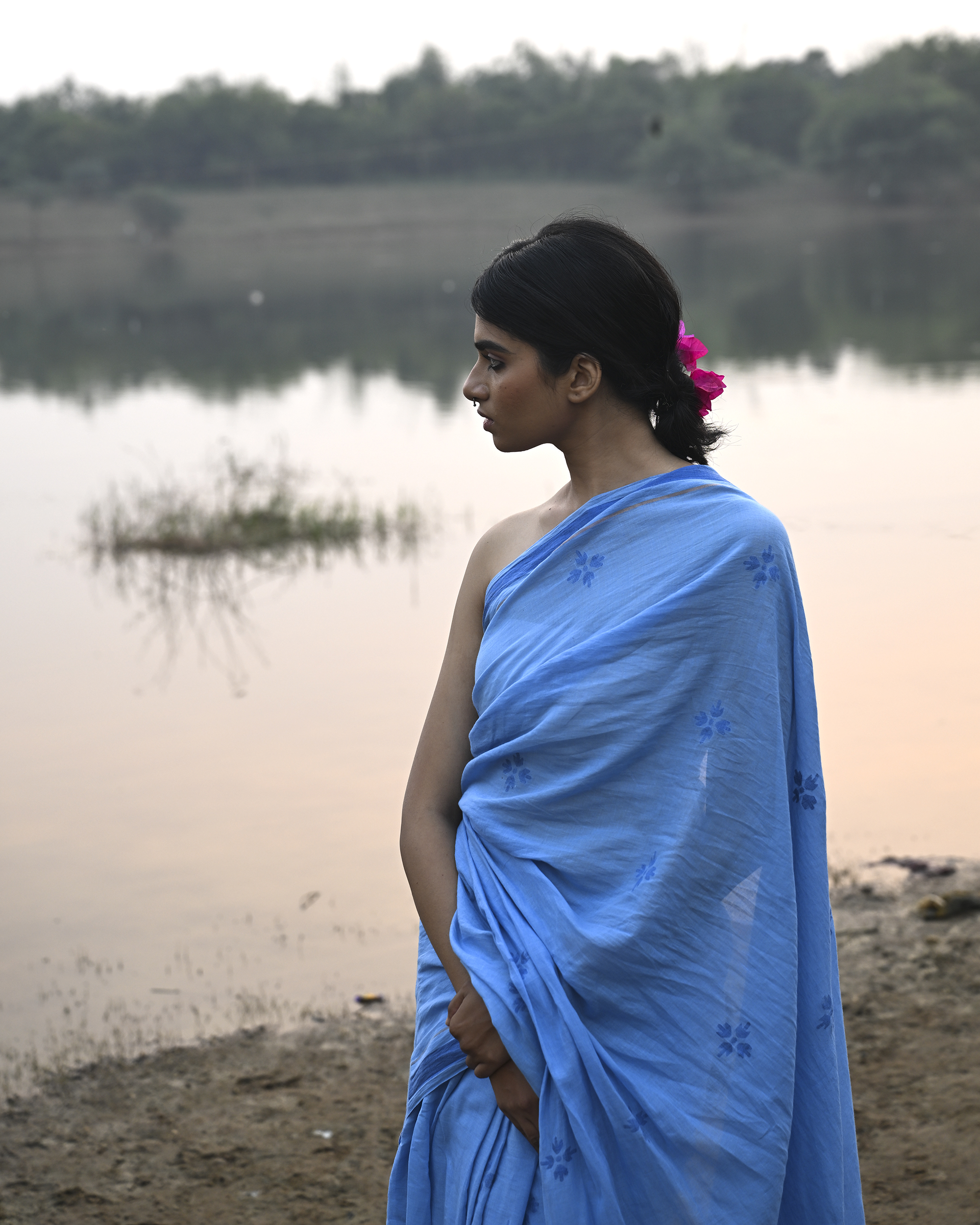 Model wearing the Powder Blue Floral Buti Jamdani Saree, a handwoven powder blue with tonal floral butis Jamdani saree with tonal floral butis scattered across the body and minimal pallu with a clean tonal finish.