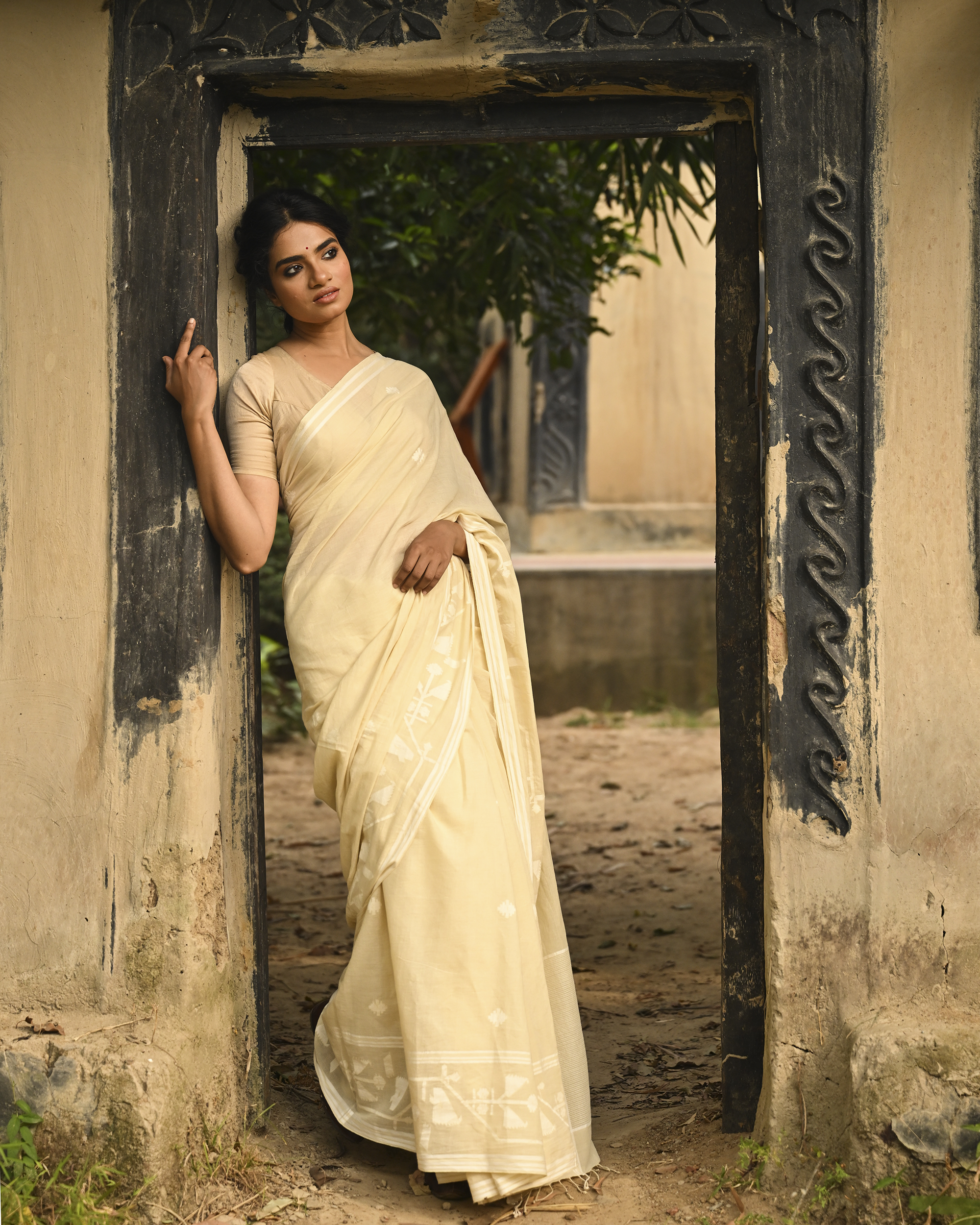 Model wearing the Buttercream Tone-on-Tone Jamdani Saree, a handwoven buttercream with tone-on-tone weaving Jamdani saree with quiet woven motifs in a soft monochrome language and whisper-light pallu with subtle border luminosity.