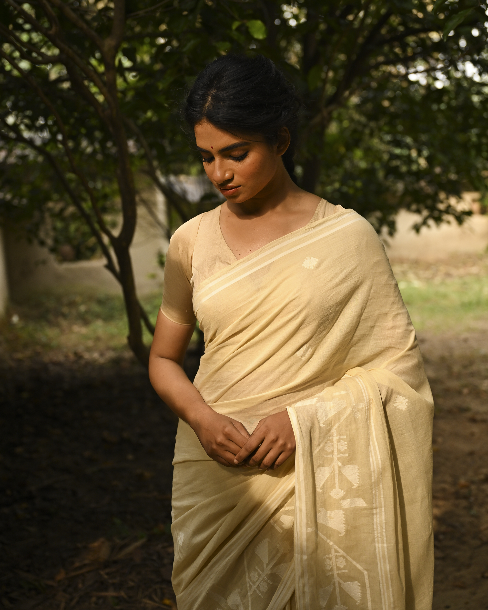 Model wearing the Buttercream Tone-on-Tone Jamdani Saree, a handwoven buttercream with tone-on-tone weaving Jamdani saree with quiet woven motifs in a soft monochrome language and whisper-light pallu with subtle border luminosity.