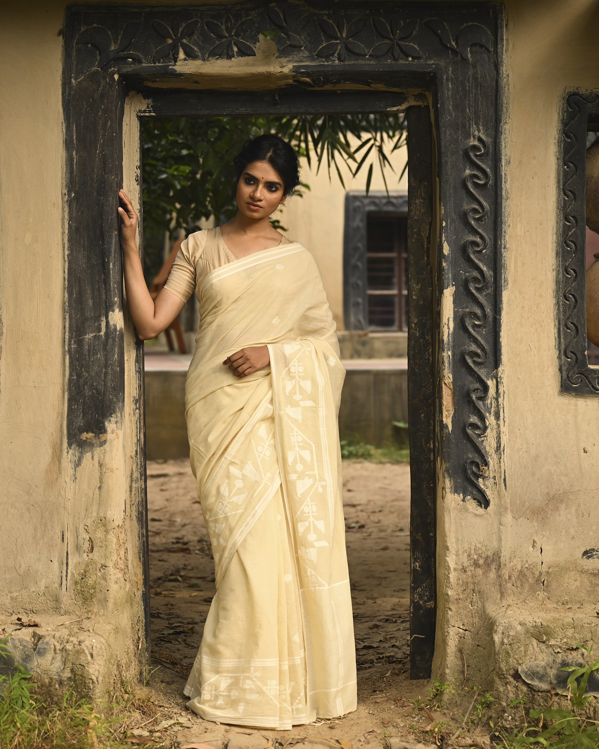 Model wearing the Buttercream Tone-on-Tone Jamdani Saree, a handwoven buttercream with tone-on-tone weaving Jamdani saree with quiet woven motifs in a soft monochrome language and whisper-light pallu with subtle border luminosity.