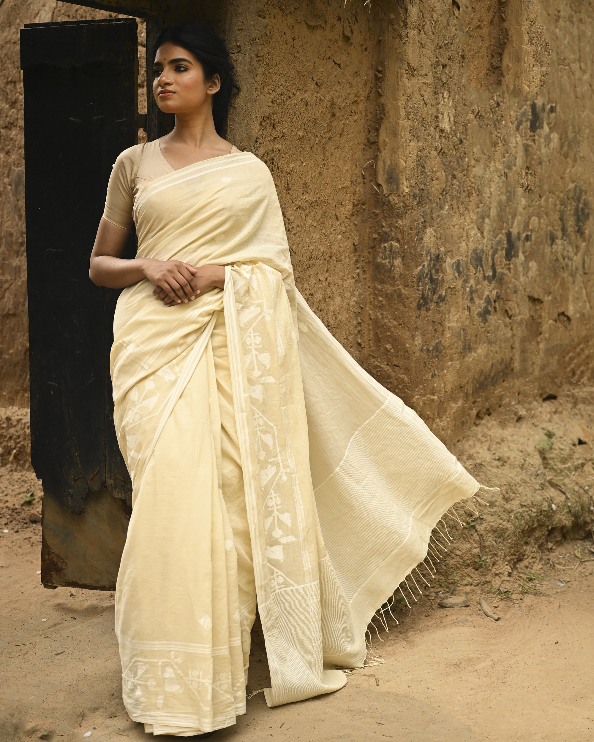 Model wearing the Buttercream Tone-on-Tone Jamdani Saree, a handwoven buttercream with tone-on-tone weaving Jamdani saree with quiet woven motifs in a soft monochrome language and whisper-light pallu with subtle border luminosity.
