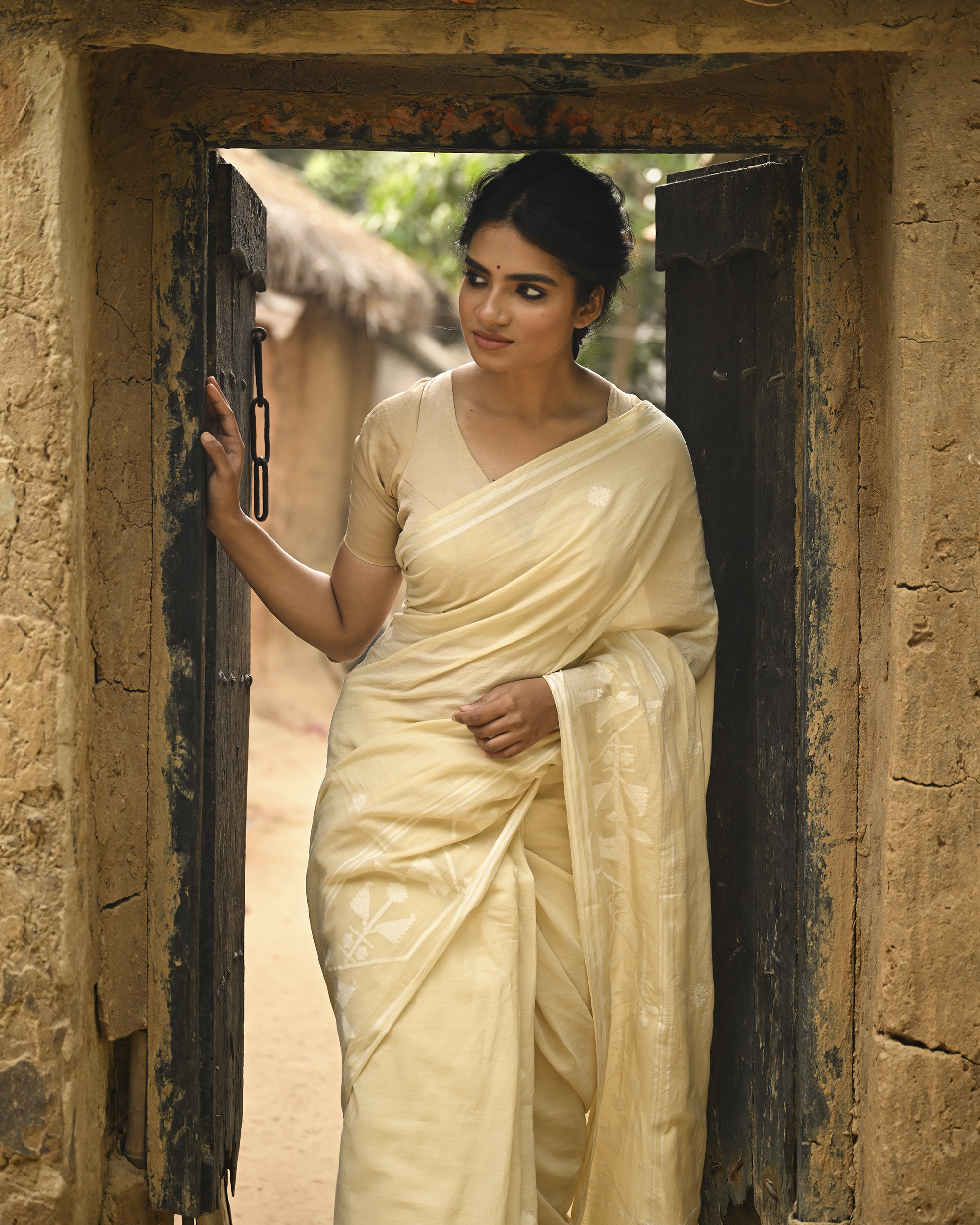 Model wearing the Buttercream Tone-on-Tone Jamdani Saree, a handwoven buttercream with tone-on-tone weaving Jamdani saree with quiet woven motifs in a soft monochrome language and whisper-light pallu with subtle border luminosity.