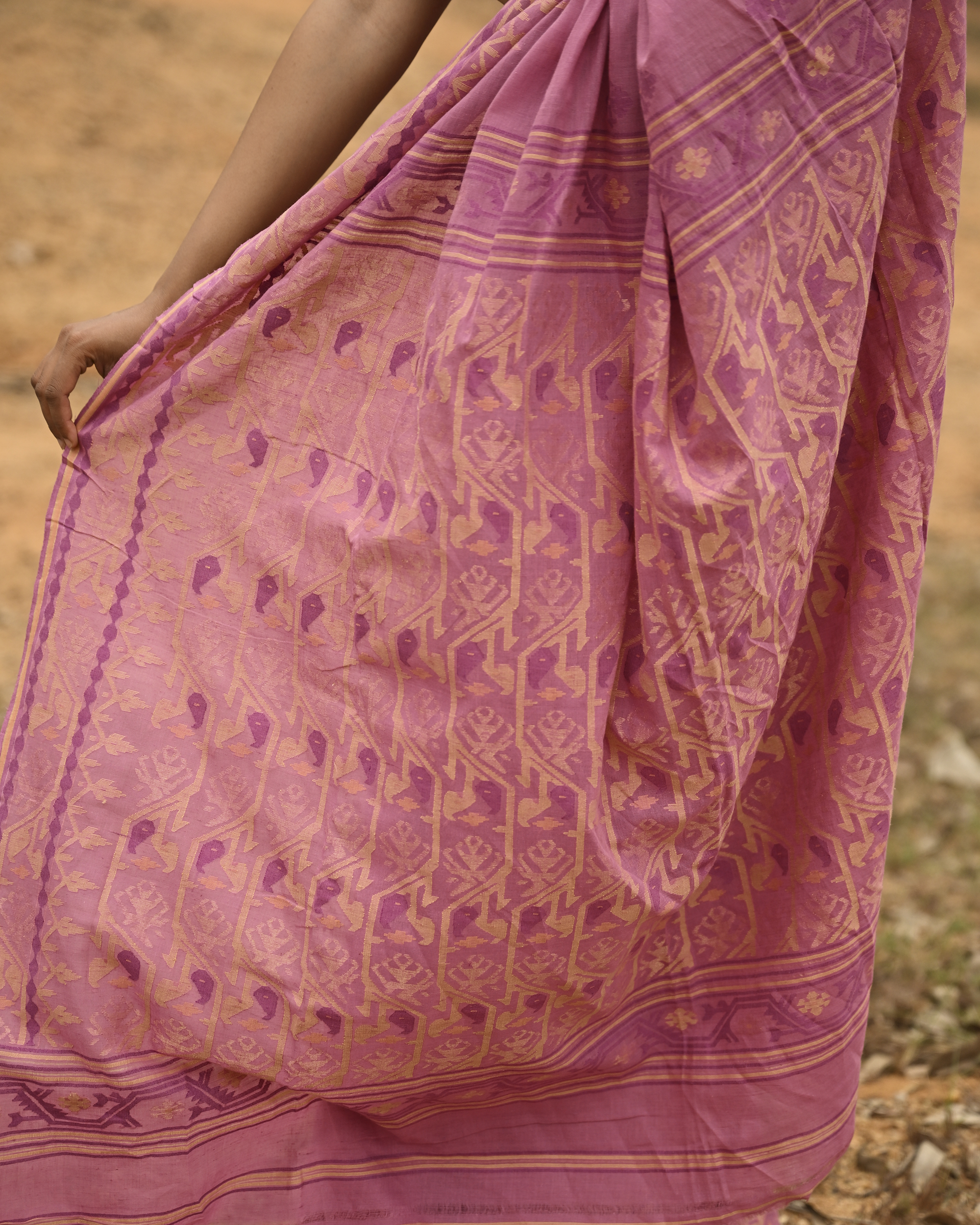 Model wearing the Mauve Gold-Detail Jamdani Saree, a handwoven muted mauve with soft gold detailing Jamdani saree with gentle woven motifs with a graceful festive border and elegant pallu with understated gold-rich work.