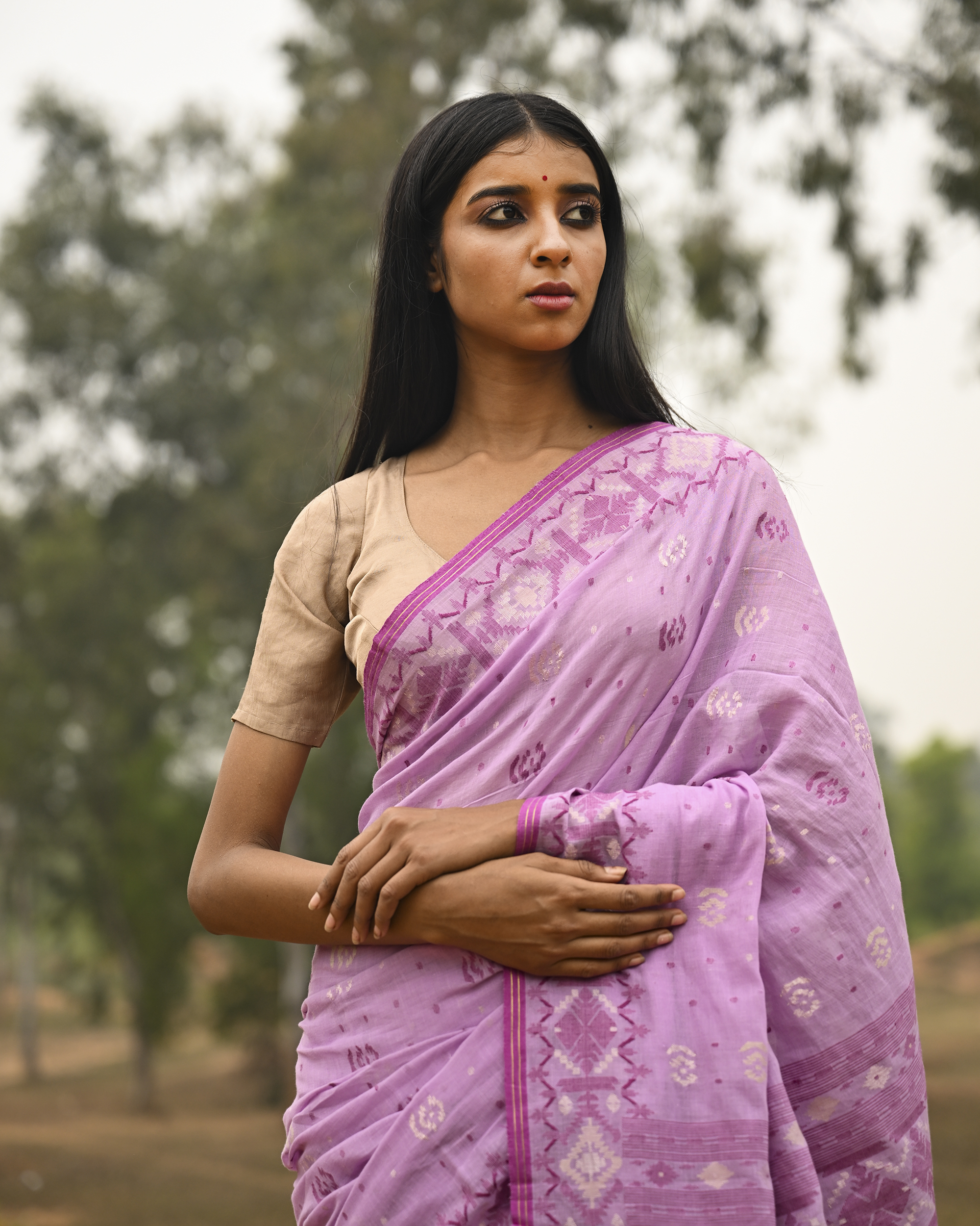 Model wearing the Lilac Silver-Pink Jamdani Saree, a handwoven luminous lilac with silvery-pink weaving Jamdani saree with scattered motifs with a softly ornate weave language and ornate pallu with luminous woven detailing.