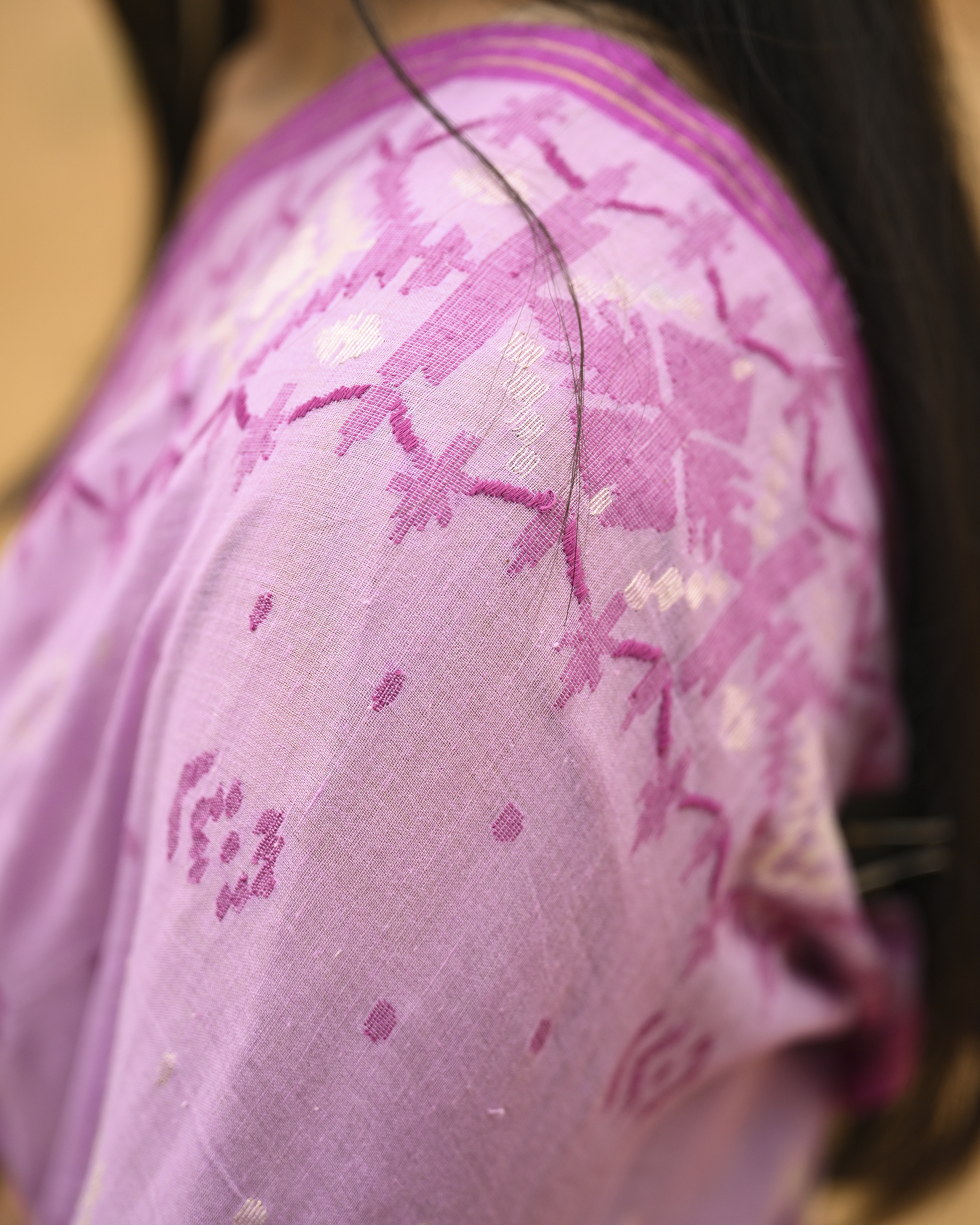 Model wearing the Lilac Silver-Pink Jamdani Saree, a handwoven luminous lilac with silvery-pink weaving Jamdani saree with scattered motifs with a softly ornate weave language and ornate pallu with luminous woven detailing.