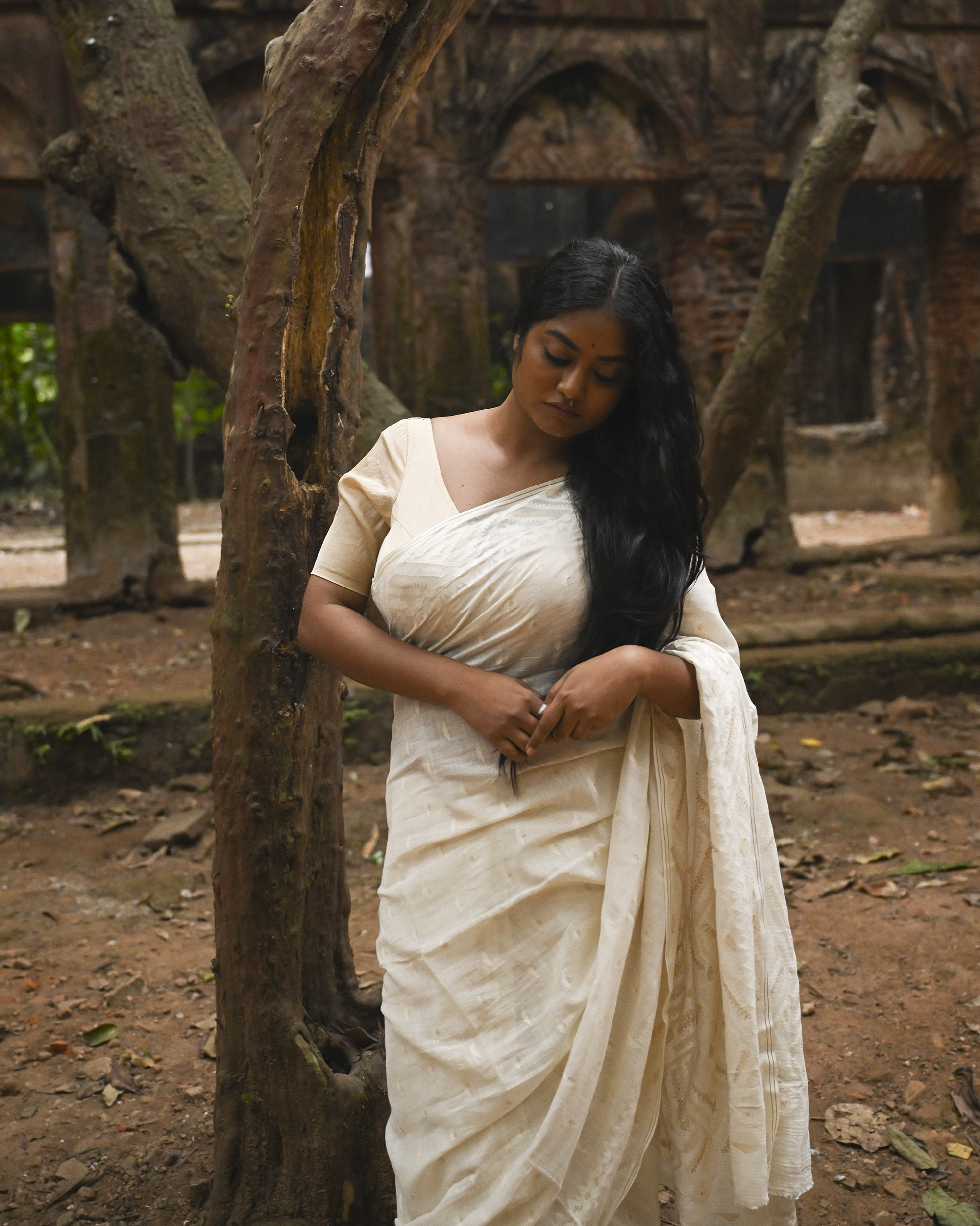 Model wearing the Ivory Whisper Jamdani Saree, a handwoven ivory-white with minimal tonal motifs Jamdani saree with whisper-soft woven motifs across a light field and minimal pallu that lets the texture lead.