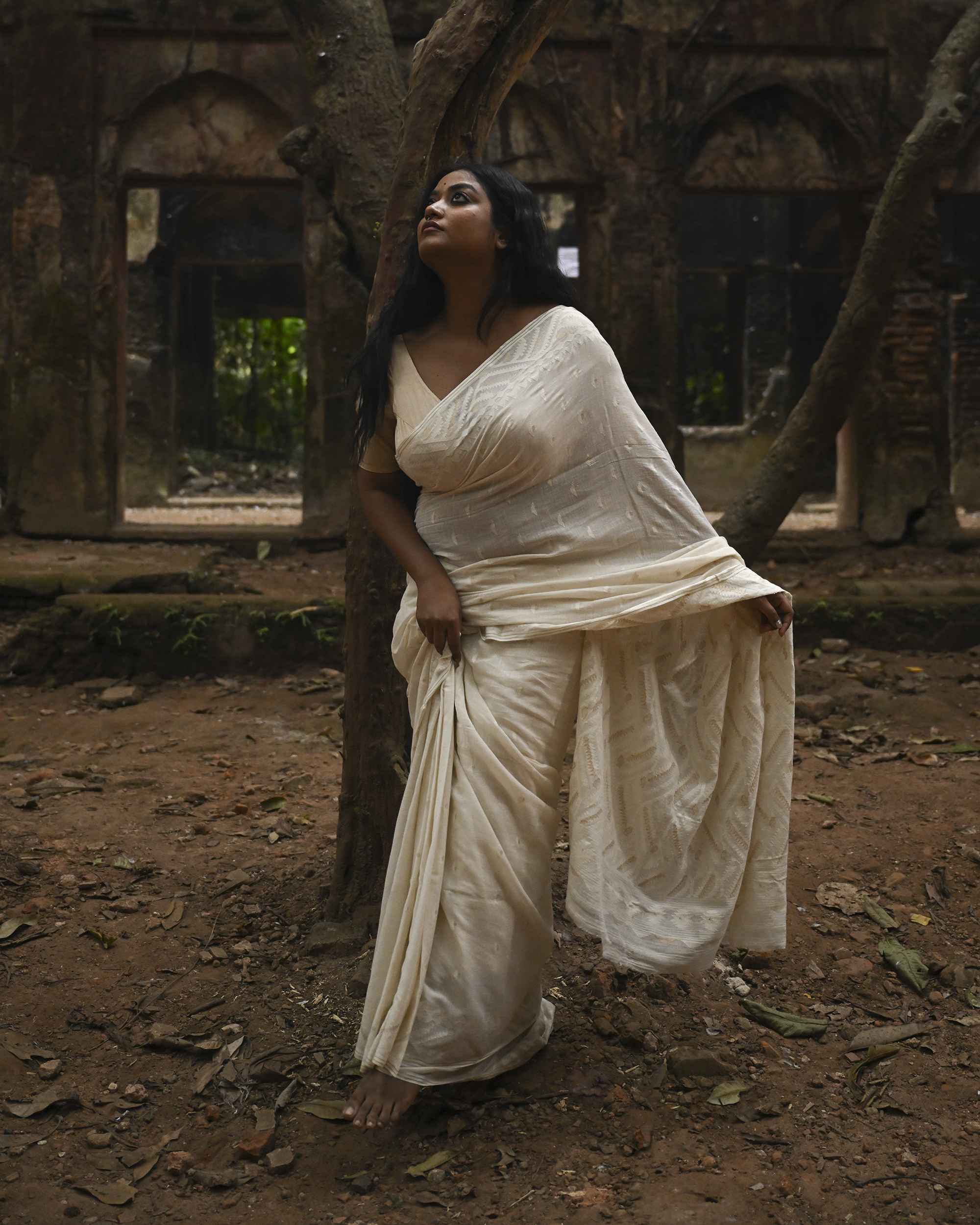 Model wearing the Ivory Whisper Jamdani Saree, a handwoven ivory-white with minimal tonal motifs Jamdani saree with whisper-soft woven motifs across a light field and minimal pallu that lets the texture lead.